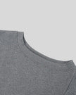 Closeup of the asymmetrical off-shoulder neckline on the Athlesi TrackLine Off-Shoulder Tee in gray