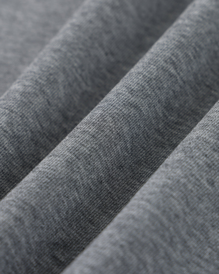 Closeup of the heavyweight cotton blend fabric texture on the Athlesi TrackLine Off-Shoulder Tee in gray