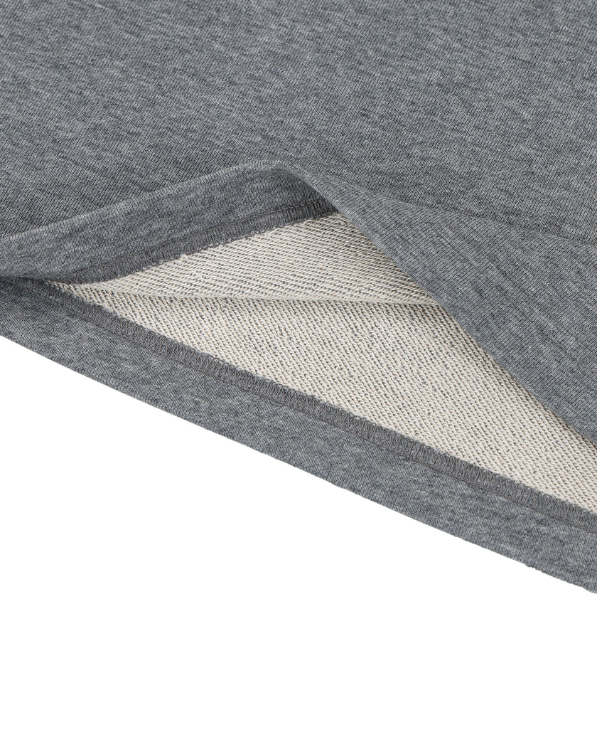 Bottom hem closeup of the Athlesi TrackLine Off-Shoulder Tee in gray