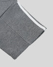 Closeup of the sleeve hem and stripe detail on the Athlesi TrackLine Off-Shoulder Tee in gray