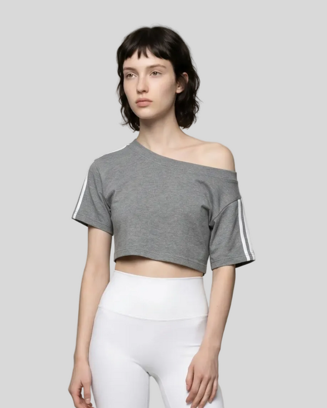 Upper body front view of a woman wearing the Athlesi TrackLine Off-Shoulder Tee in gray