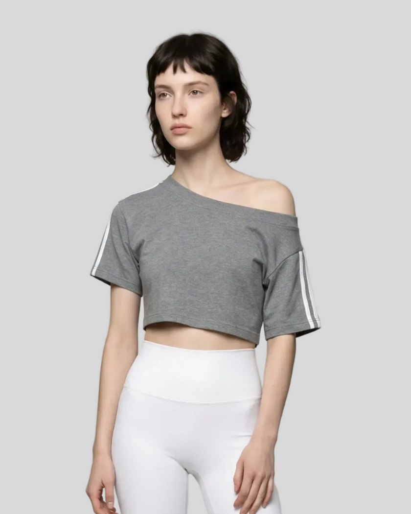 Upper body front view of a woman wearing the Athlesi TrackLine Off-Shoulder Tee in gray