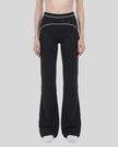 Model wearing the TrackLine Outline Flared Pants in Black viewed from the front