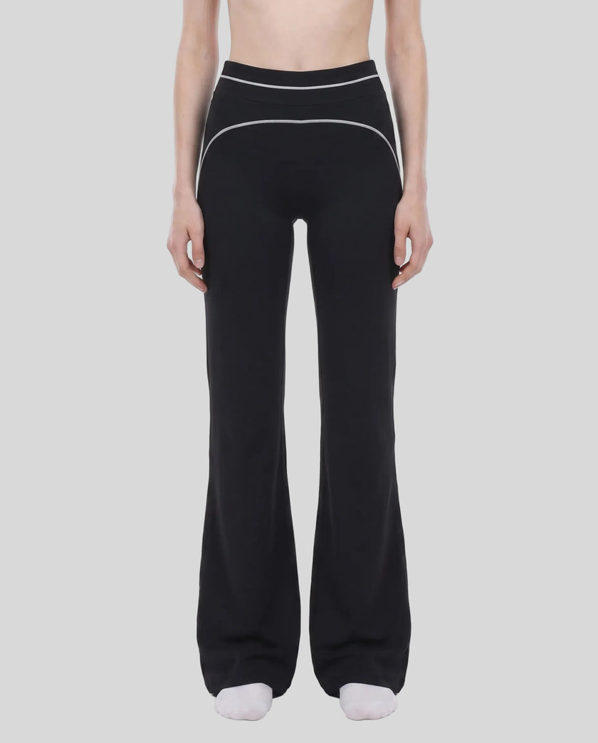 Model wearing the TrackLine Outline Flared Pants in Black viewed from the front