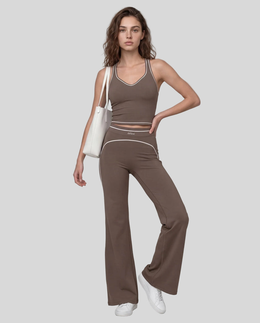 Front angled full body view of a model wearing the TrackLine Outline Flared Pants in Coffee