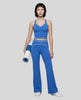 Front angled full body view of a model wearing the TrackLine Outline Flared Pants in Colorful Blue