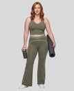 Front angled full body view of a model wearing the TrackLine Outline Flared Pants in Gray Green