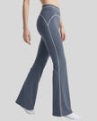 Side angled view of a model wearing the TrackLine Outline Flared Pants in Haze Blue