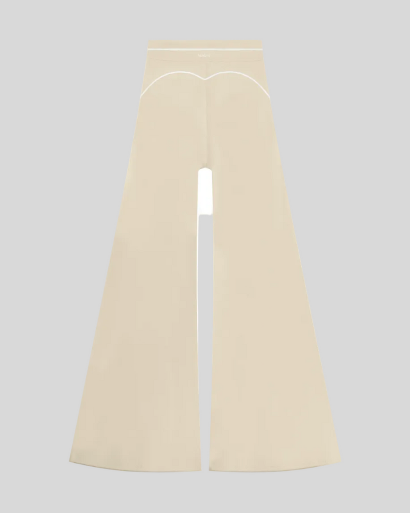 TrackLine Outline Flared Pants in Light Apricot back view showcasing the sculpting back seam and flared silhouette