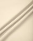 Close-up of the smooth stretch performance fabric used on the TrackLine Outline Flared Pants in Light Apricot