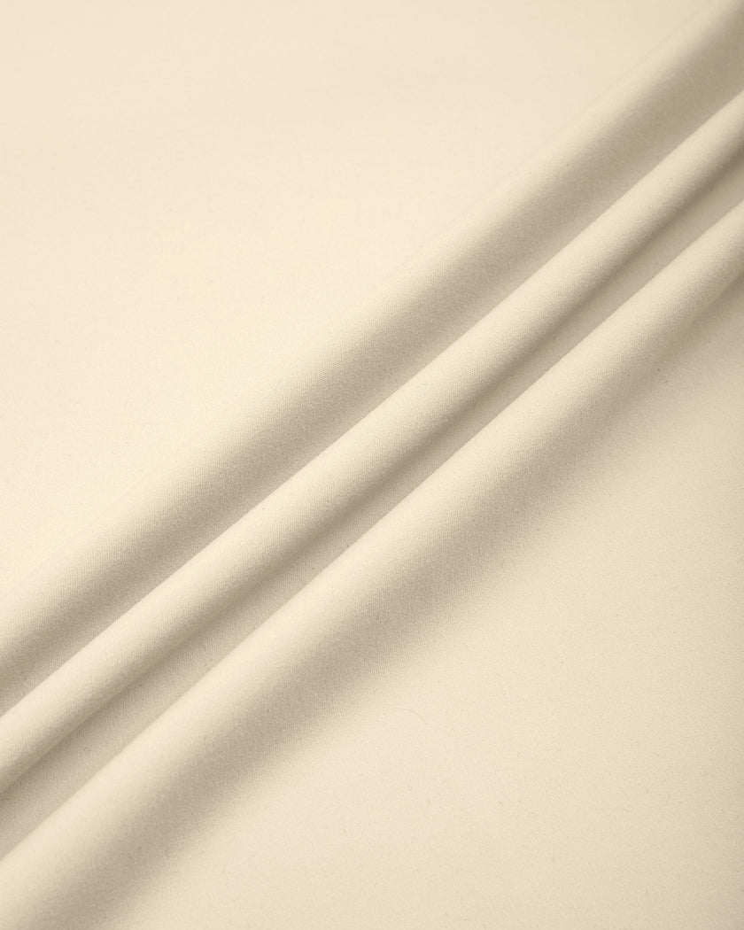 Close-up of the smooth stretch performance fabric used on the TrackLine Outline Flared Pants in Light Apricot
