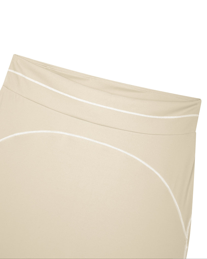 Close-up of the high-rise front waistband on the TrackLine Outline Flared Pants in Light Apricot