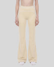 Model wearing the TrackLine Outline Flared Pants in Light Apricot viewed from the front