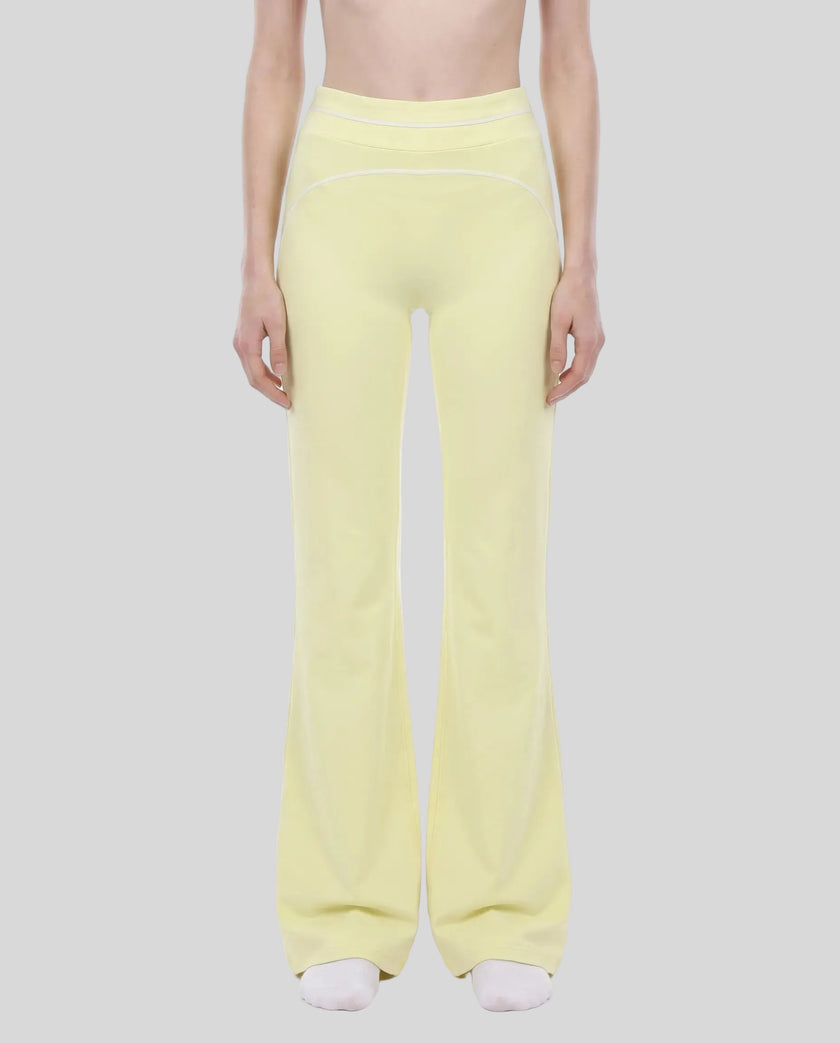 Model wearing the TrackLine Outline Flared Pants in Light Green viewed from the front