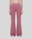 Model wearing the TrackLine Outline Flared Pants in Purple viewed from the front