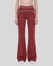 Model wearing the TrackLine Outline Flared Pants in Red viewed from the front