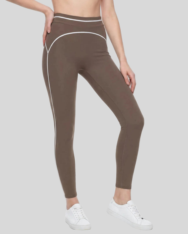 Front angled view of a model wearing the TrackLine Outline Leggings in Coffee