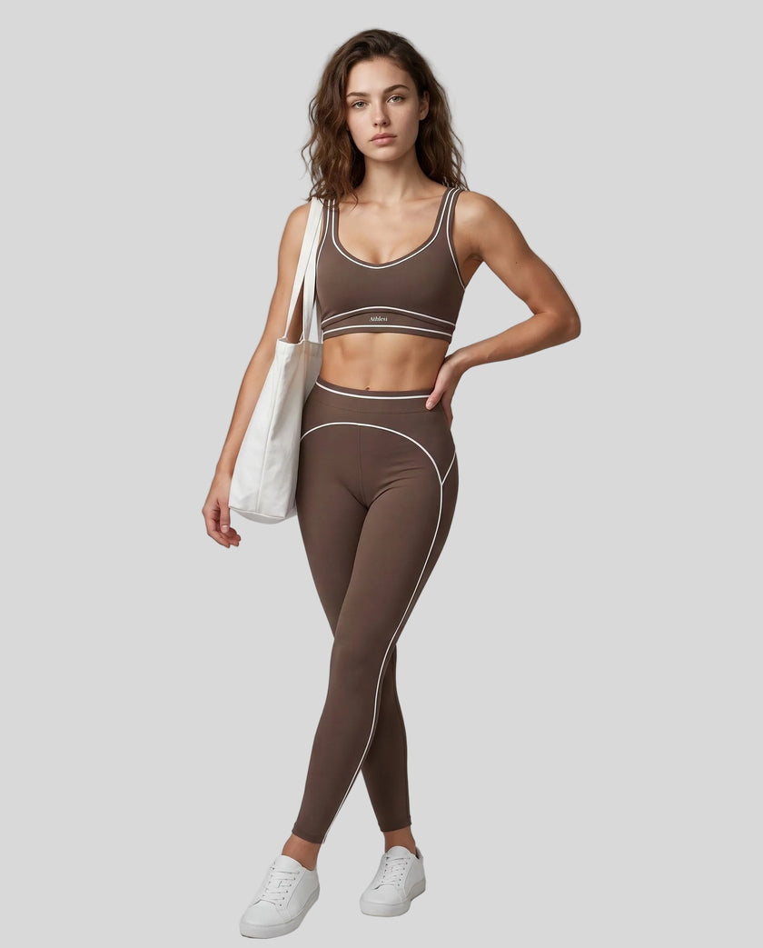 Front angled full body view of a model wearing the TrackLine Outline Leggings in Coffee