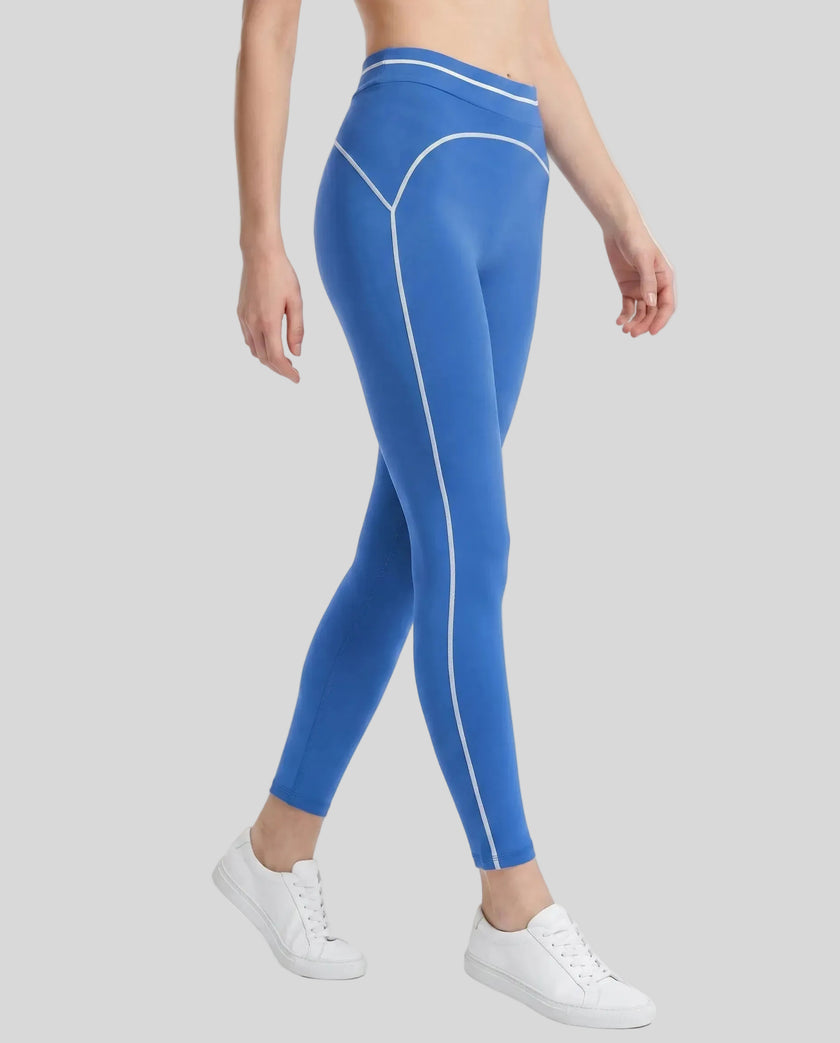 Side angled view of a model wearing the TrackLine Outline Leggings in Colorful Blue