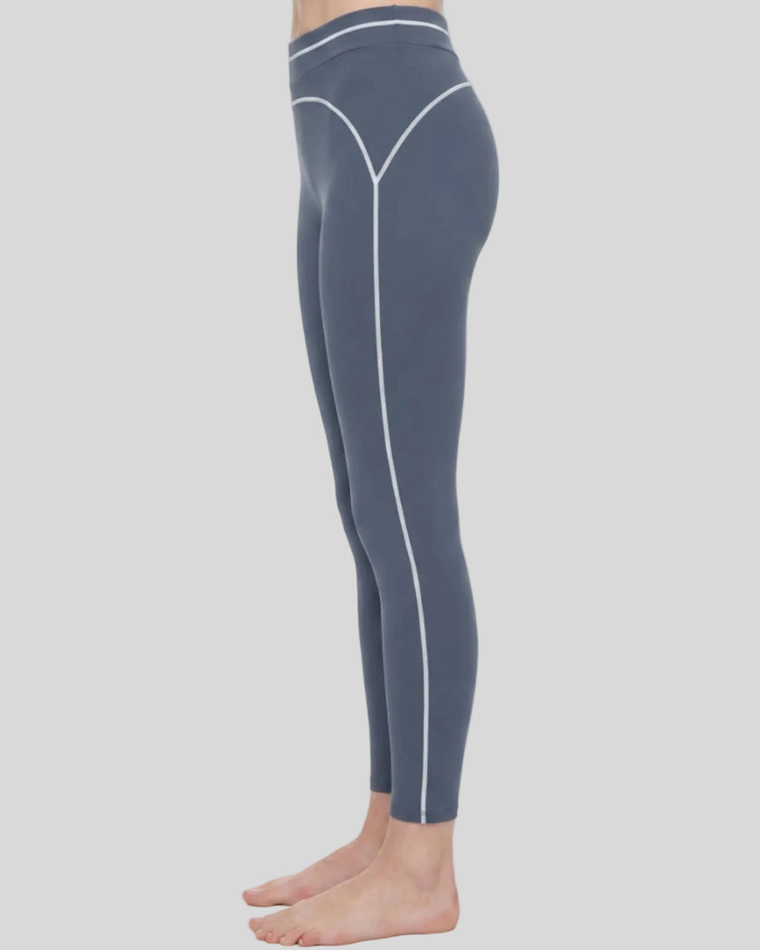 Side view of a model wearing the TrackLine Outline Leggings in Haze Blue