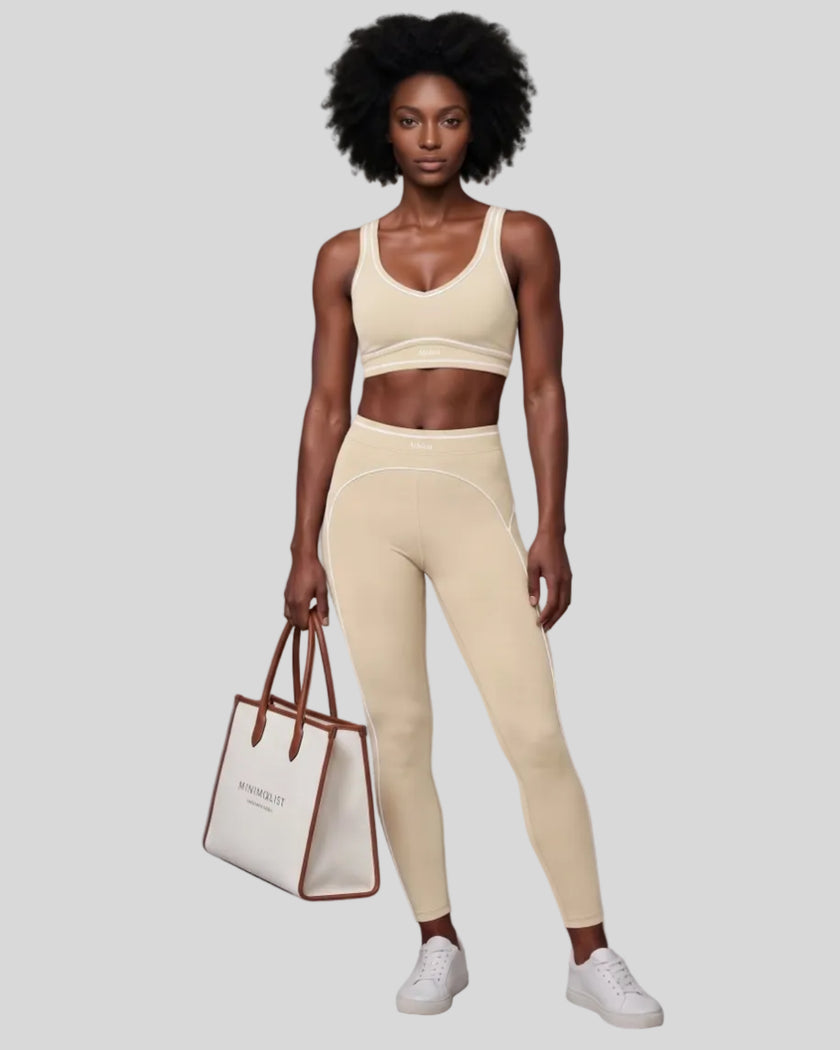 Front angled full body view of a model wearing the TrackLine Outline Leggings in Light Apricot