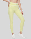 Front angled view of a model wearing the TrackLine Outline Leggings in Light Green