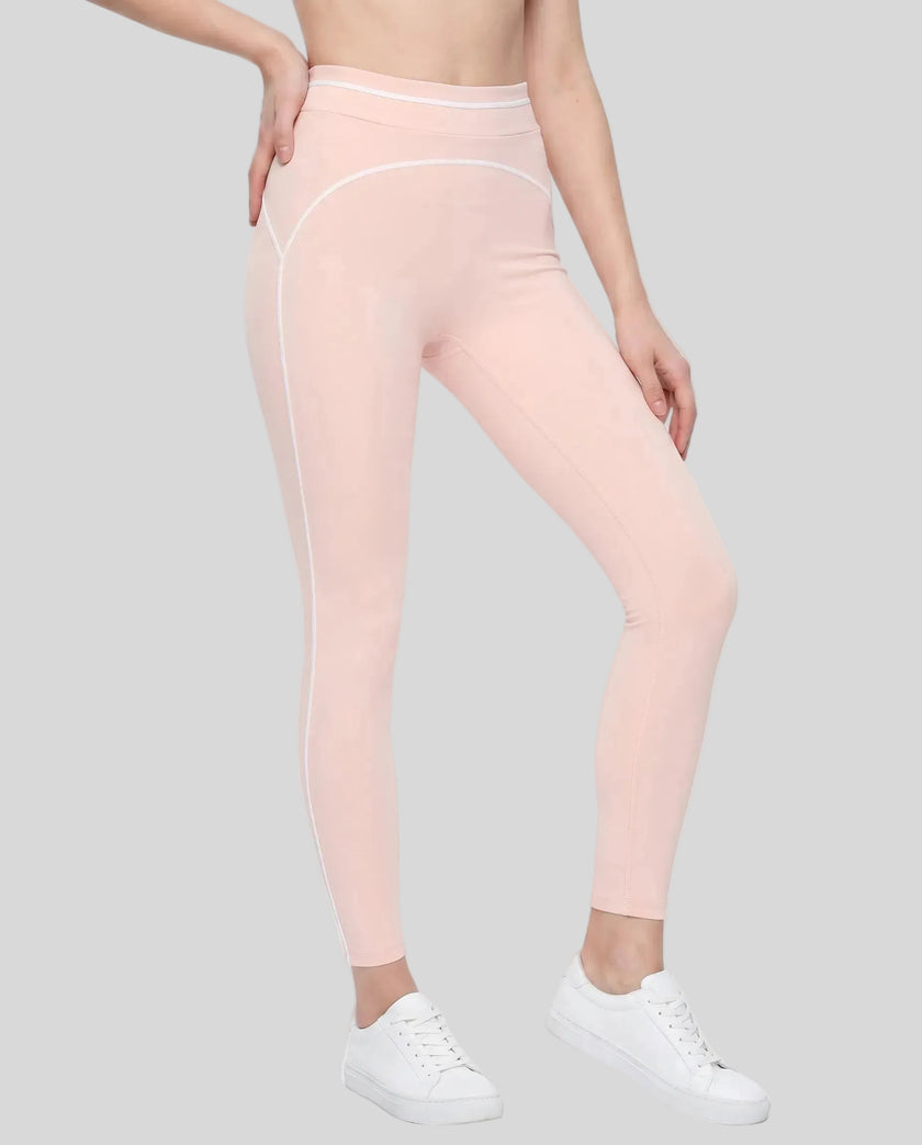 Front angled view of a model wearing the TrackLine Outline Leggings in Light Pink