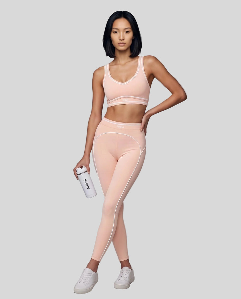 Front angled full body view of a model wearing the TrackLine Outline Leggings in Light Pink