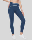Front angled view of a model wearing the TrackLine Outline Leggings in Navy Blue