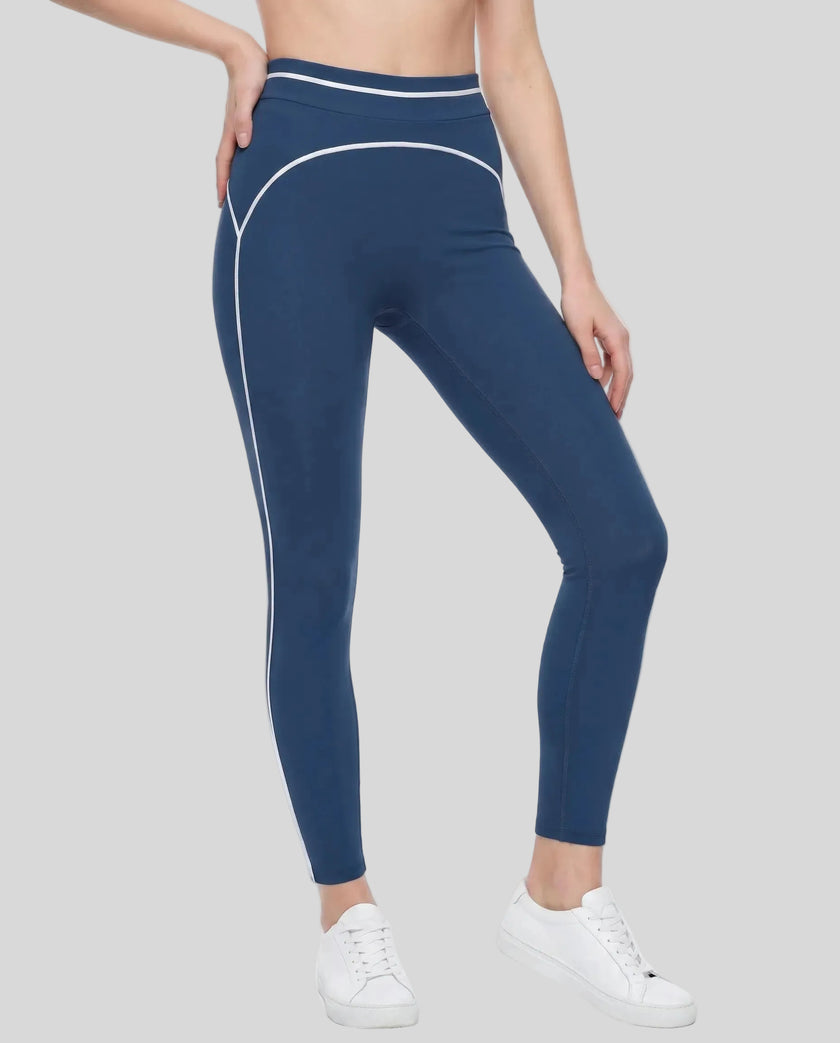 Front angled view of a model wearing the TrackLine Outline Leggings in Navy Blue