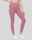 Front angled view of a model wearing the TrackLine Outline Leggings in Purple