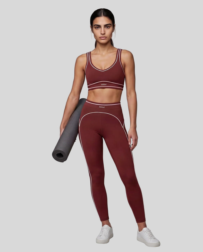Front angled full body view of a model wearing the TrackLine Outline Leggings in Red