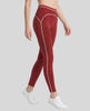 Side angled view of a model wearing the TrackLine Outline Leggings in Red