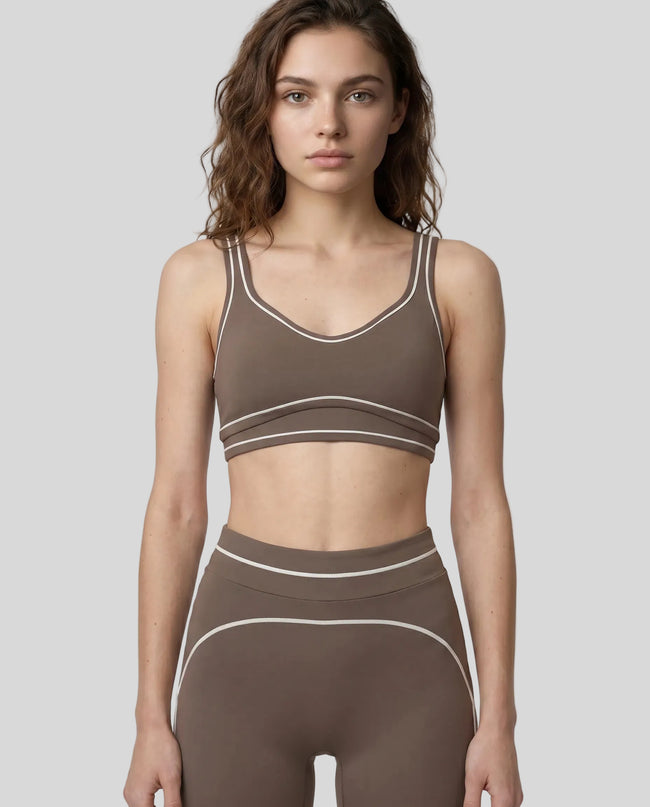 Model wearing the TrackLine Outline Sports Bra in Coffee viewed from the front