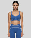Model wearing the TrackLine Outline Sports Bra in Colorful Blue viewed from the front