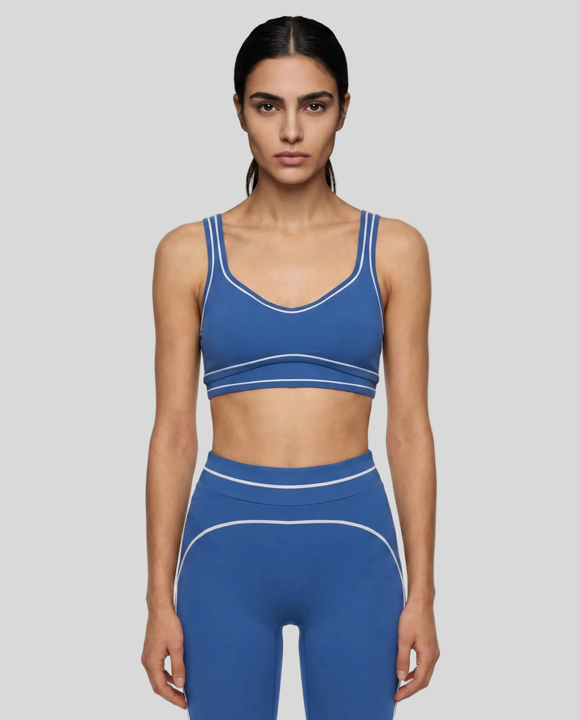 Model wearing the TrackLine Outline Sports Bra in Colorful Blue viewed from the front