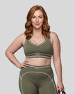 Model wearing the TrackLine Outline Sports Bra in Gray Green viewed from the front