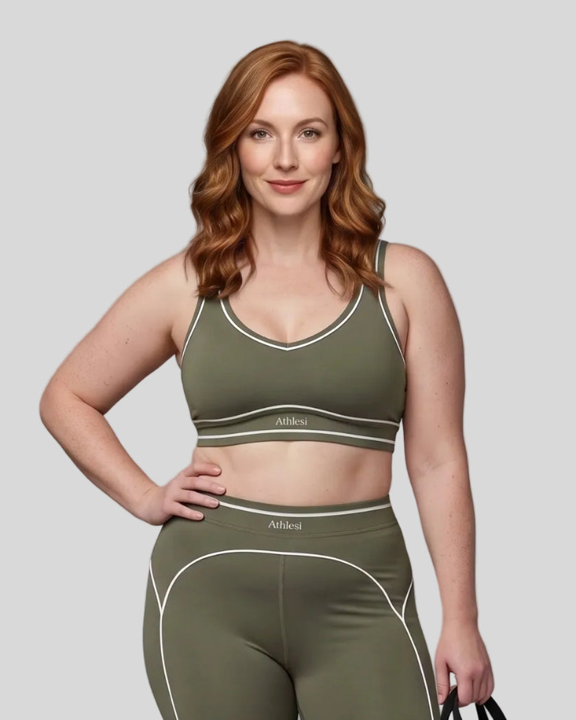 Model wearing the TrackLine Outline Sports Bra in Gray Green viewed from the front