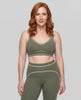 Model wearing the TrackLine Outline Sports Bra in Gray Green viewed from the front