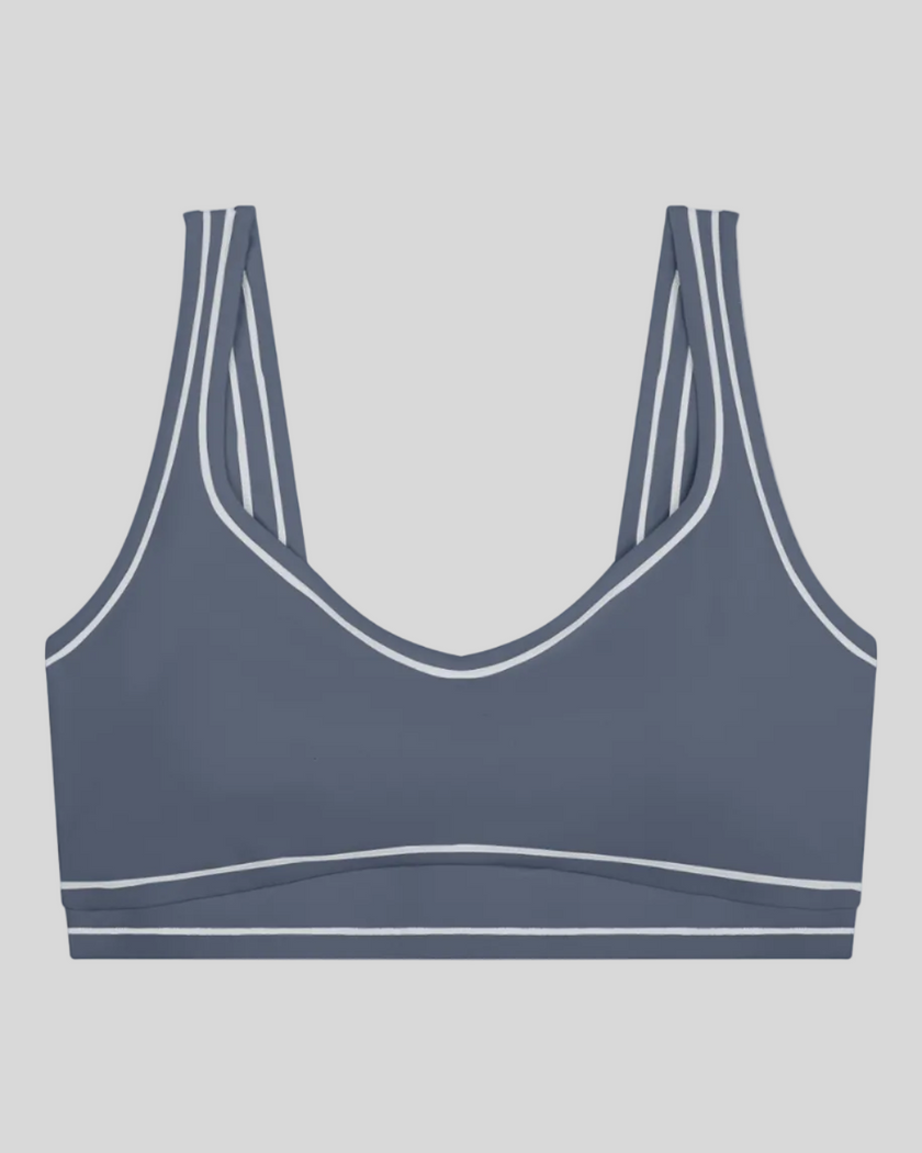 TrackLine Outline Sports Bra in Haze Blue front view featuring contrast piping and a supportive fit