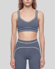 Model wearing the TrackLine Outline Sports Bra in Haze Blue viewed from the front