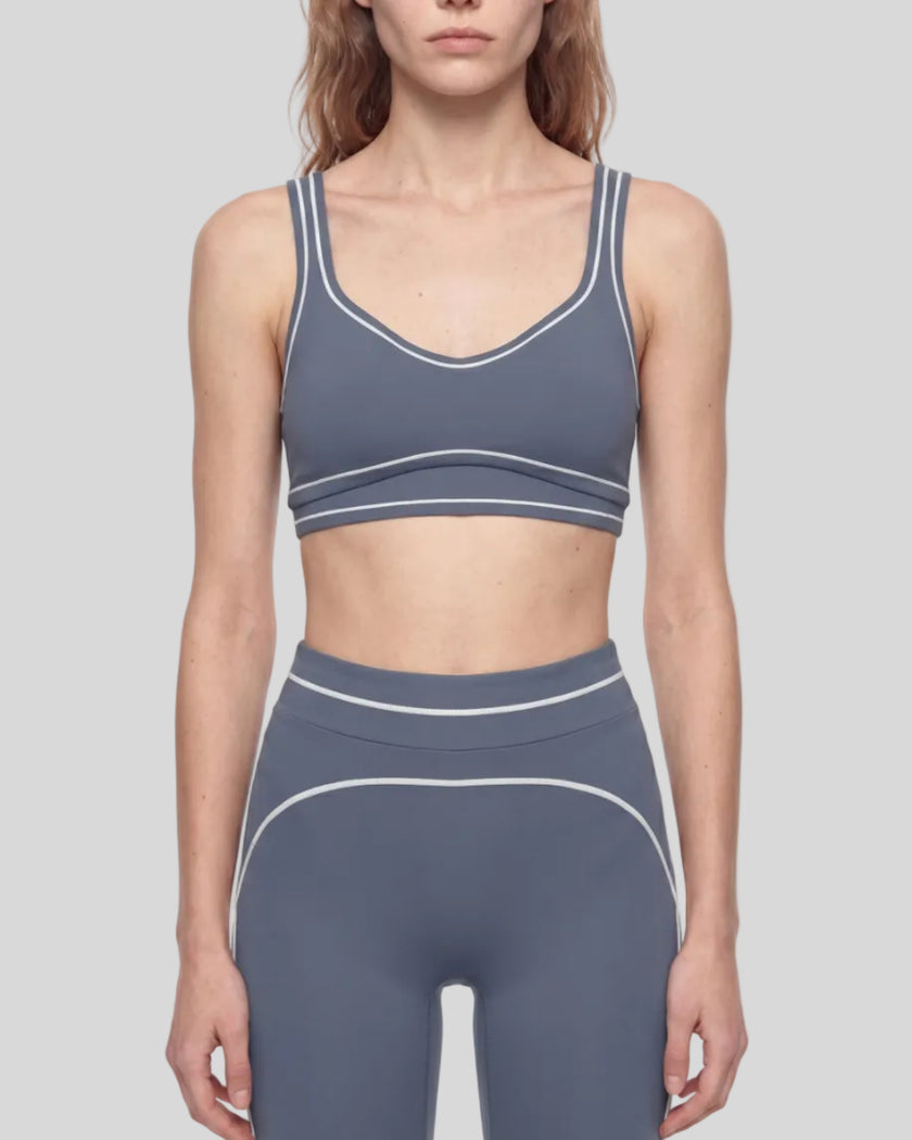 Model wearing the TrackLine Outline Sports Bra in Haze Blue viewed from the front