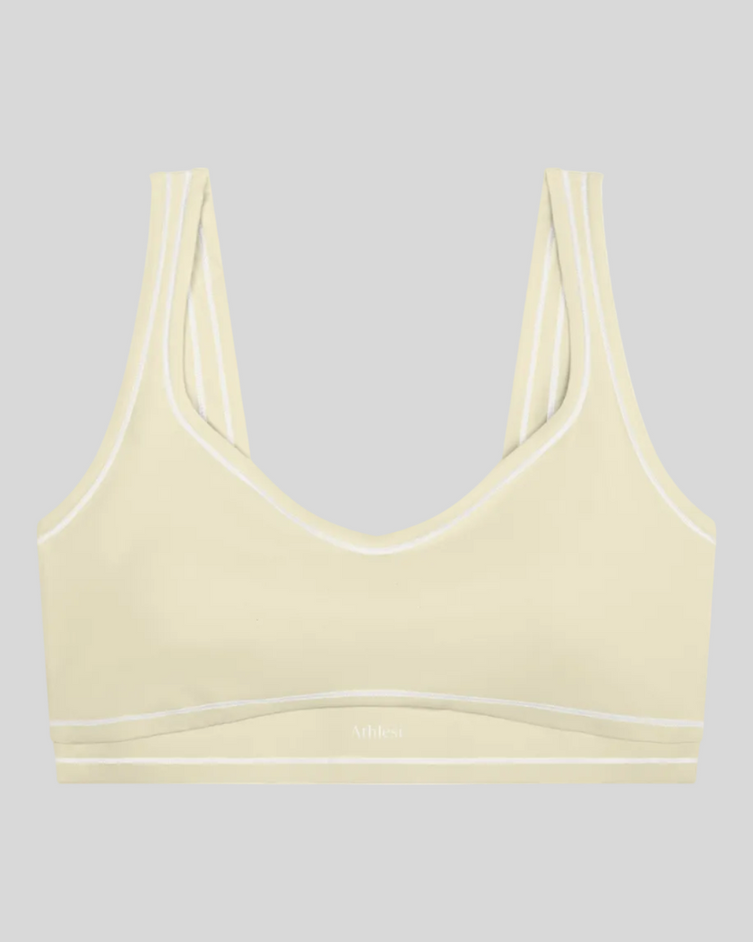 TrackLine Outline Sports Bra in Light Apricot front view featuring contrast piping and a supportive fit