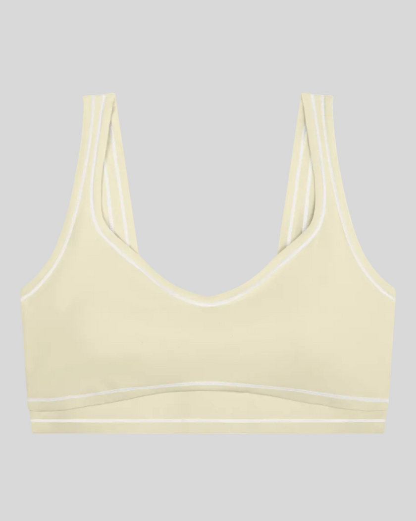 TrackLine Outline Sports Bra in Light Apricot front view featuring contrast piping and a supportive fit