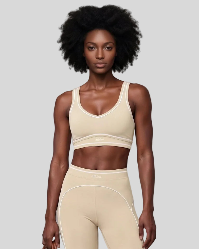 Model wearing the TrackLine Outline Sports Bra in Light Apricot viewed from the front