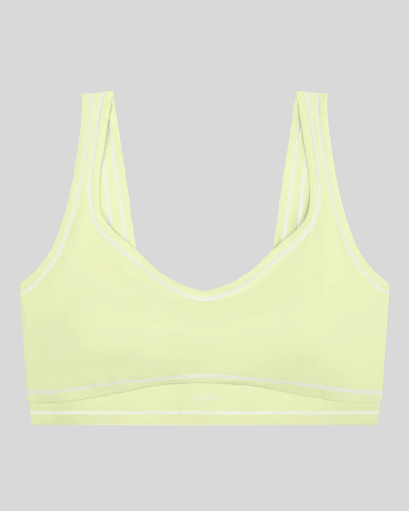 TrackLine Outline Sports Bra in Light Green front view featuring contrast piping and a supportive fit