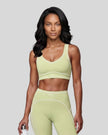 Model wearing the TrackLine Outline Sports Bra in Light Green viewed from the front
