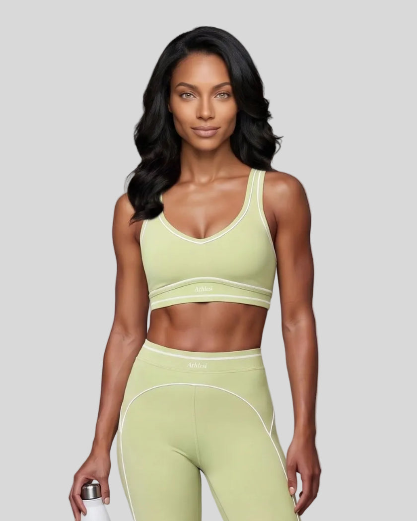 Model wearing the TrackLine Outline Sports Bra in Light Green viewed from the front