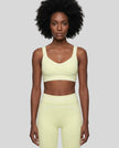 Model wearing the TrackLine Outline Sports Bra in Light Green viewed from the front