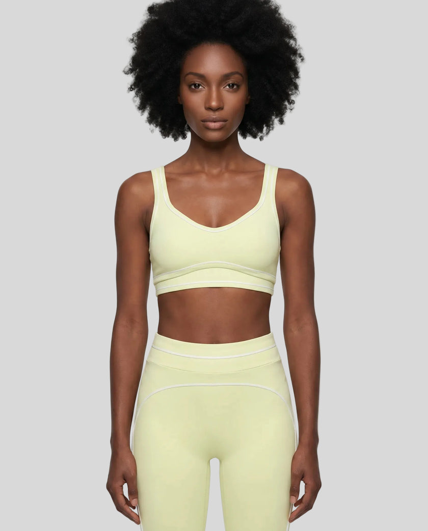 Model wearing the TrackLine Outline Sports Bra in Light Green viewed from the front